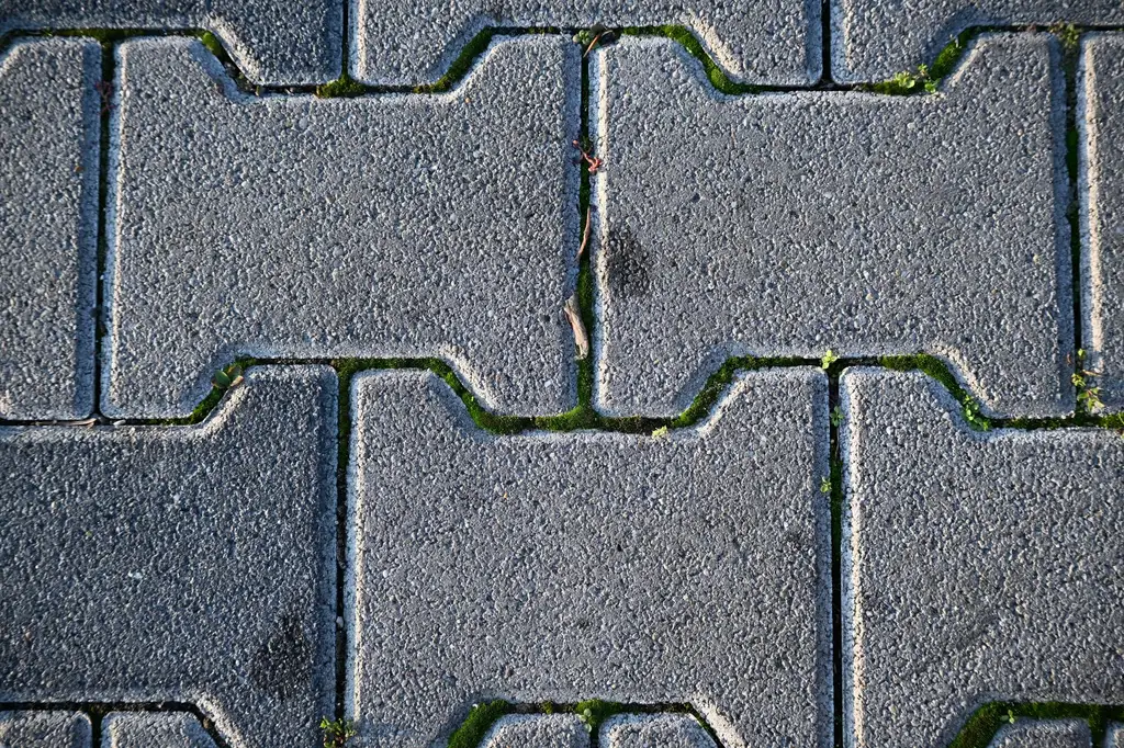 Interlocking concrete paving blocks laid tight with sand-filled joints
